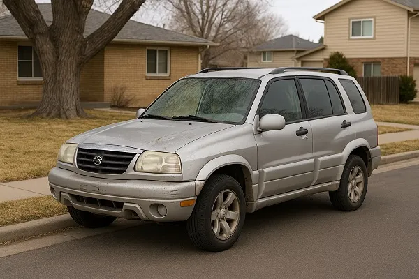 Image of a used Suzuki SUV parked in a Colorado residential area, representing how SellMyCarColorado buys Suzuki vehicles in used and junk condition.